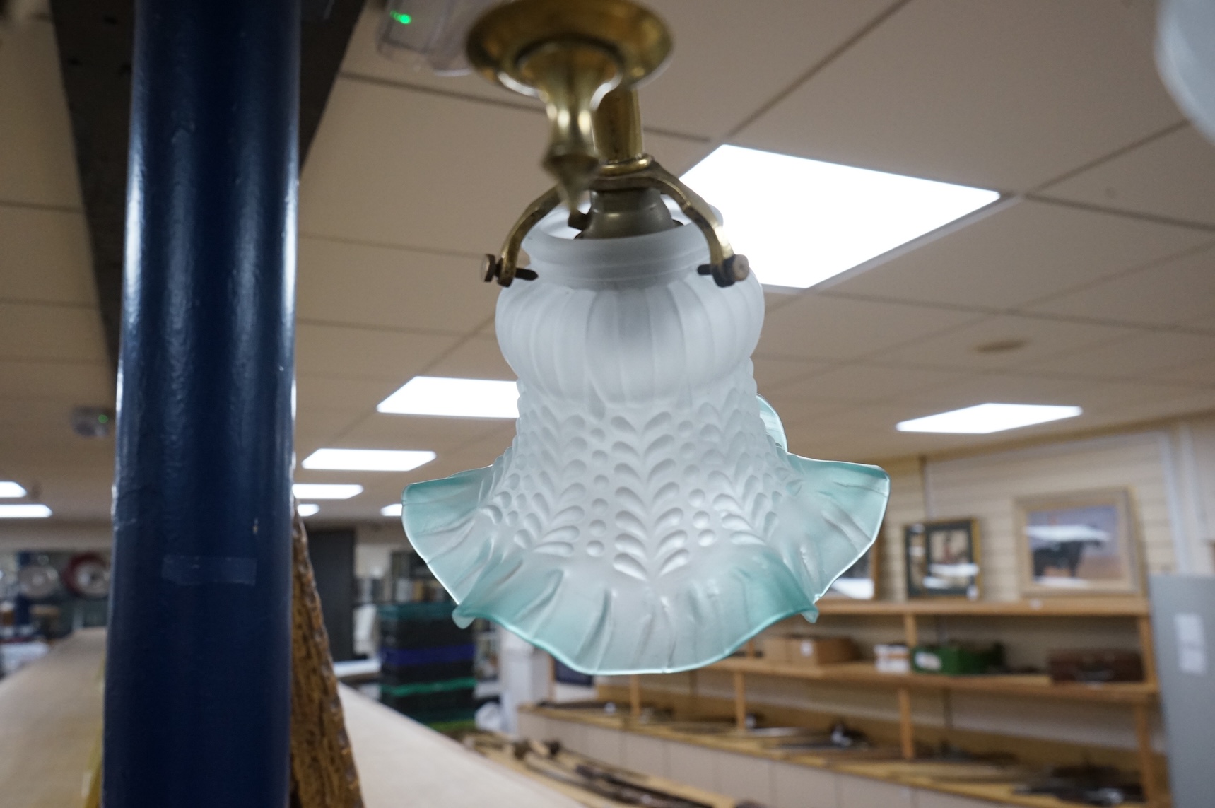 A brass three branch frosted shade ceiling light